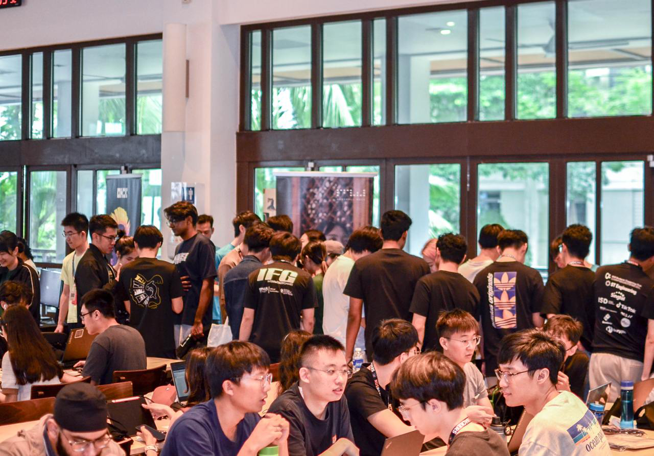 Participants crowding around sponsor booths