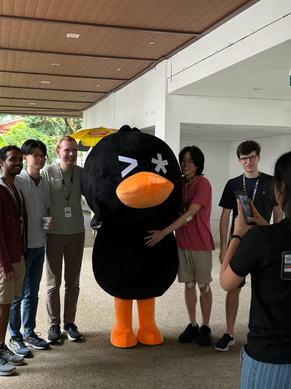 Quackers mascot posing with participants